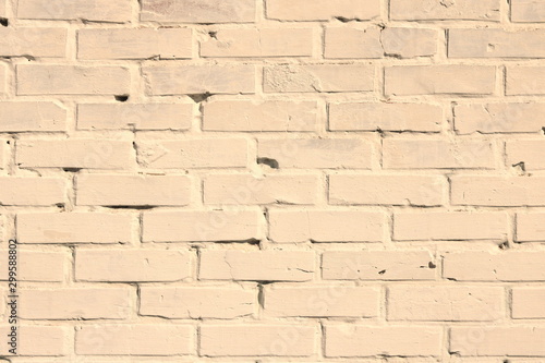 Brick wall of beige painted brick close up