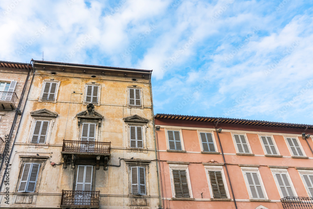 brown and pink apartments with shutters in Ascoli Piceno, Italy
