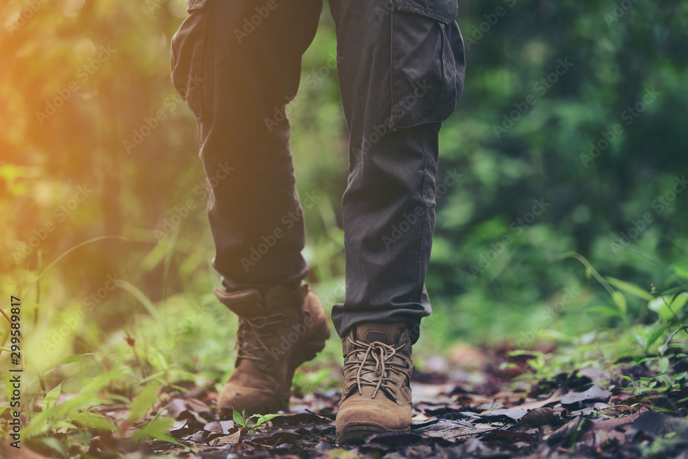 foot of young Man Traveler with backpack relaxing outdoor with rocky mountains on background Summer vacations and Lifestyle hiking concept. foot of young Man Traveler with backpack relaxing outdoor with rocky mountains on background Summer vacations and Lifestyle hiking concept.