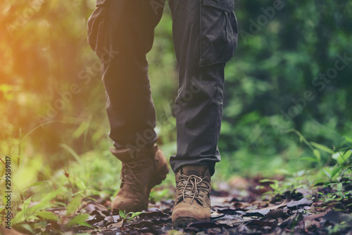 foot of young Man Traveler with backpack relaxing outdoor with rocky mountains on background Summer vacations and Lifestyle hiking concept.