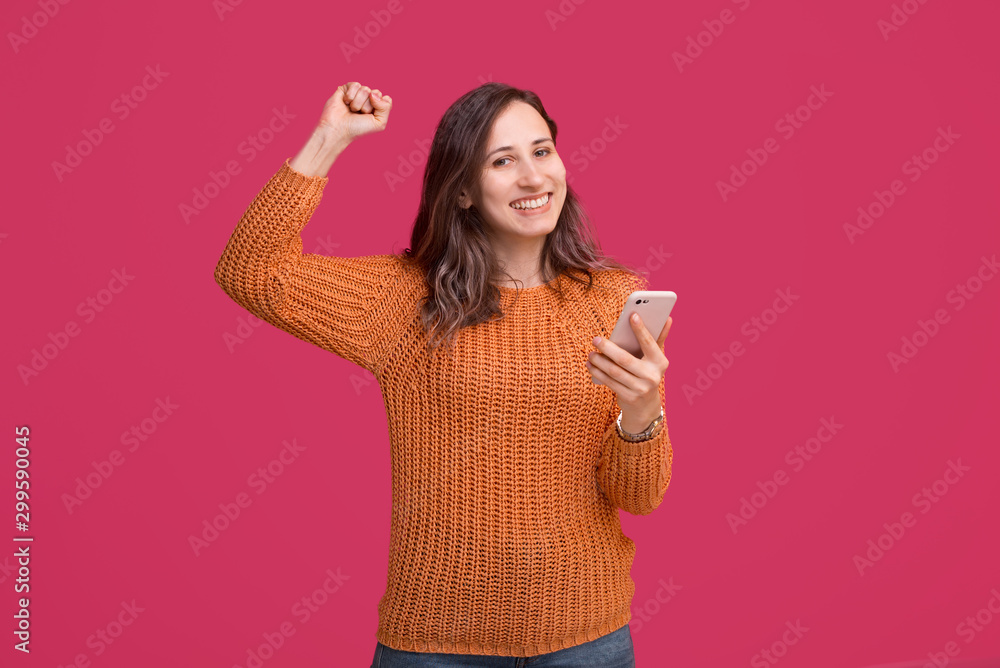 Happy beautiful woman using smartphone and celebrate victory Happy beautiful woman using smartphone and celebrate victory