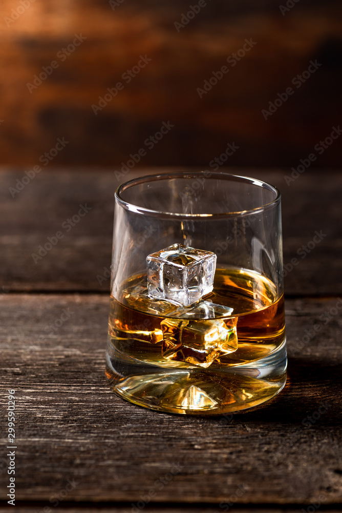 Glass of whiskey with ice cubes Glass of whiskey with ice cubes