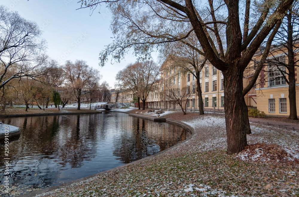 Yusupov Garden in the center of St. Petersburg in late autumn, ponds and trees in the rays of the evening sun Yusupov Garden in the center of St. Petersburg in late autumn, ponds and trees in the rays of the evening sun