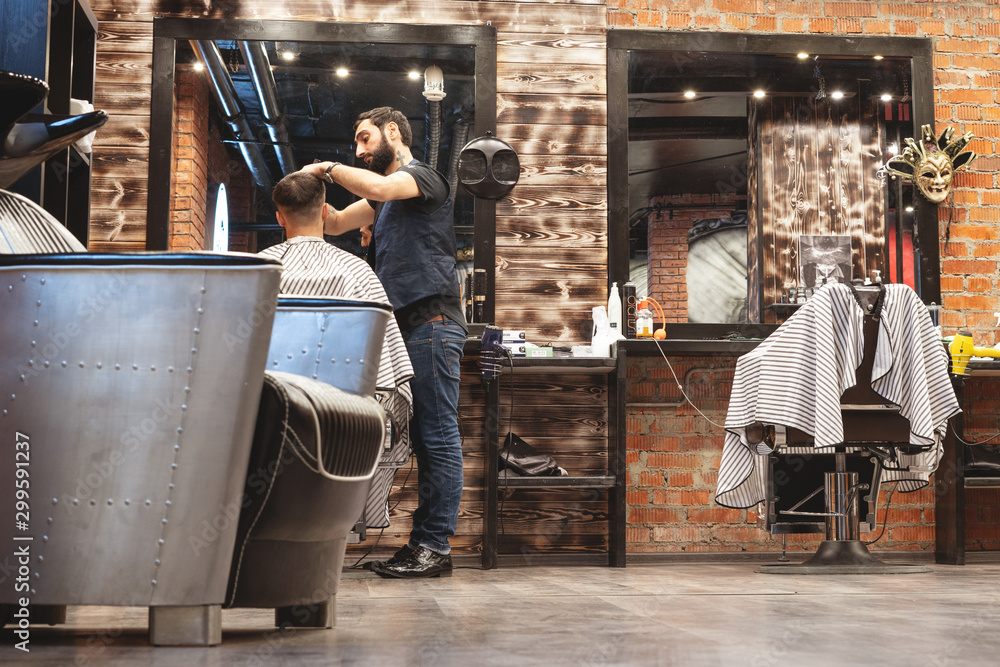 Chair for washing your hair in a barbershop. Barbershop interior. Brutal place. Leather armchair with metal upholstery. Selective focus. Chair for washing your hair in a barbershop. Barbershop interior. Brutal place. Leather armchair with metal upholstery. Selective focus.