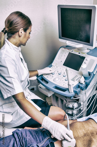 Belly ultrasound at hospital. Elderly patient with confident female doctor