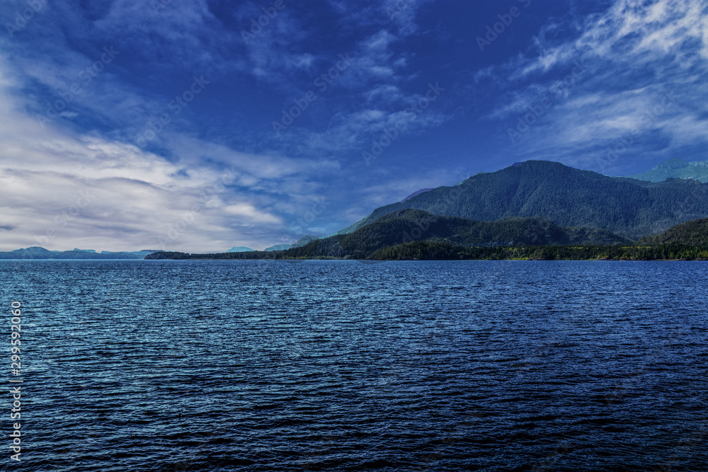 Clouds gather over the mountains behind Kennedy Lake