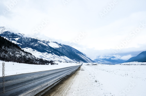 Wallpaper Mural Winter roads in the mountains. The road in the snow-capped mountains. Winter landscape.  Torontodigital.ca