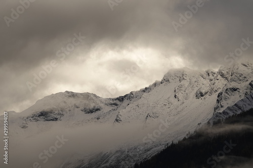 beautiful view to the alps with fog, clouds and fresh snow on the mountains in autumn © Chamois huntress