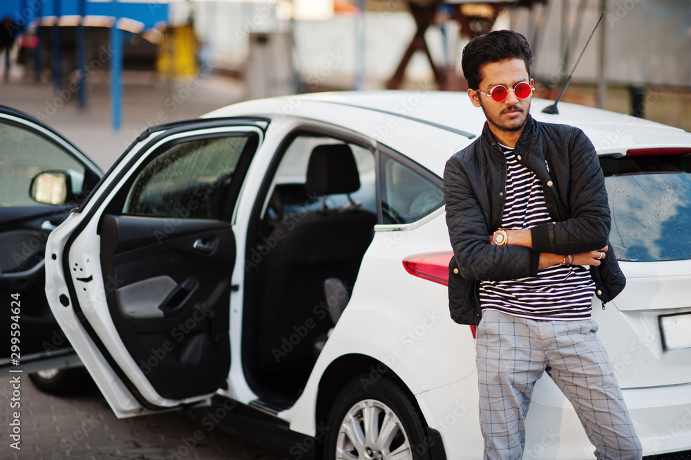 Fototapeta premium South asian man or indian male wear red eyeglasses stand near his white transportation on car wash.