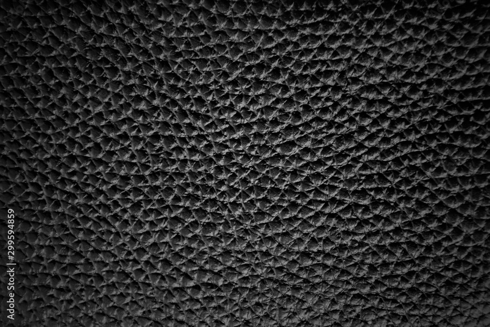 Black leather texture, background with vignetting.