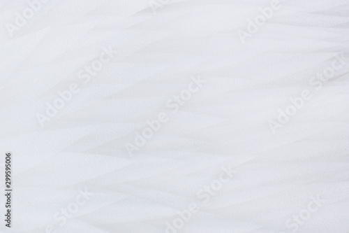 White soft background of white feathers, soft selective focus, blur.