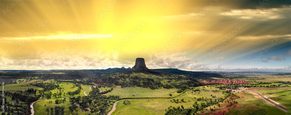 Panoramic aerial view of Devils Tower National Monument at summer sunset, Wyoming from drone perspective