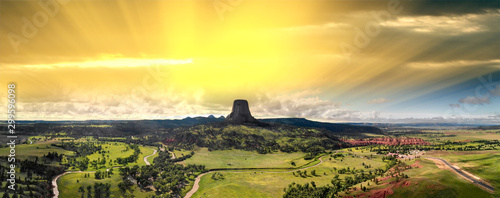 Panoramic aerial view of Devils Tower National Monument at summer sunset, Wyoming from drone perspective