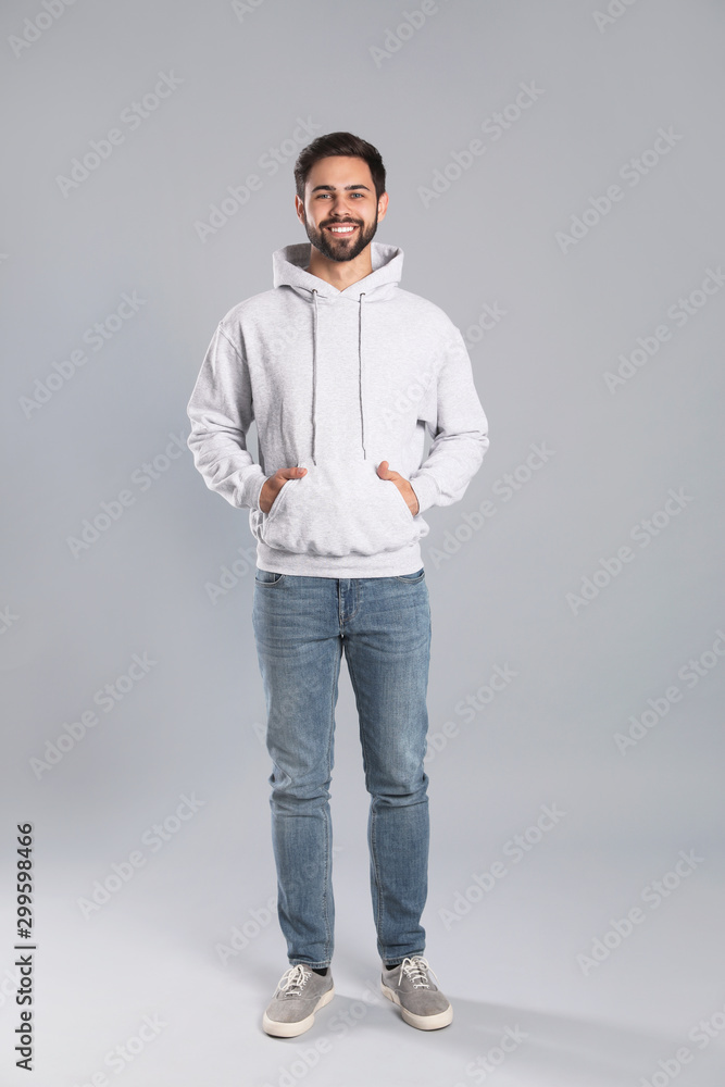 Full length portrait of young man in sweater on grey background. Mock up for design Full length portrait of young man in sweater on grey background. Mock up for design