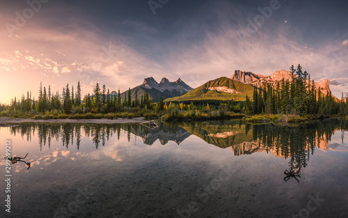 Panorama of Three sisters mountain reflection on pond at sunrise in autumn at Banff national park