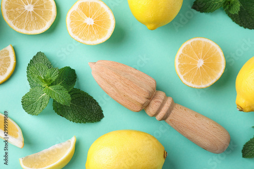 Foto Flat lay composition with fresh lemons on turquoise background