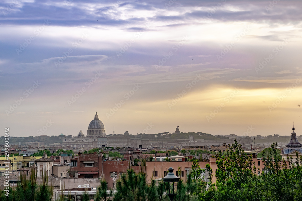 Skyline of the city of Rome at sunset. Sky with clouds and orange tones.