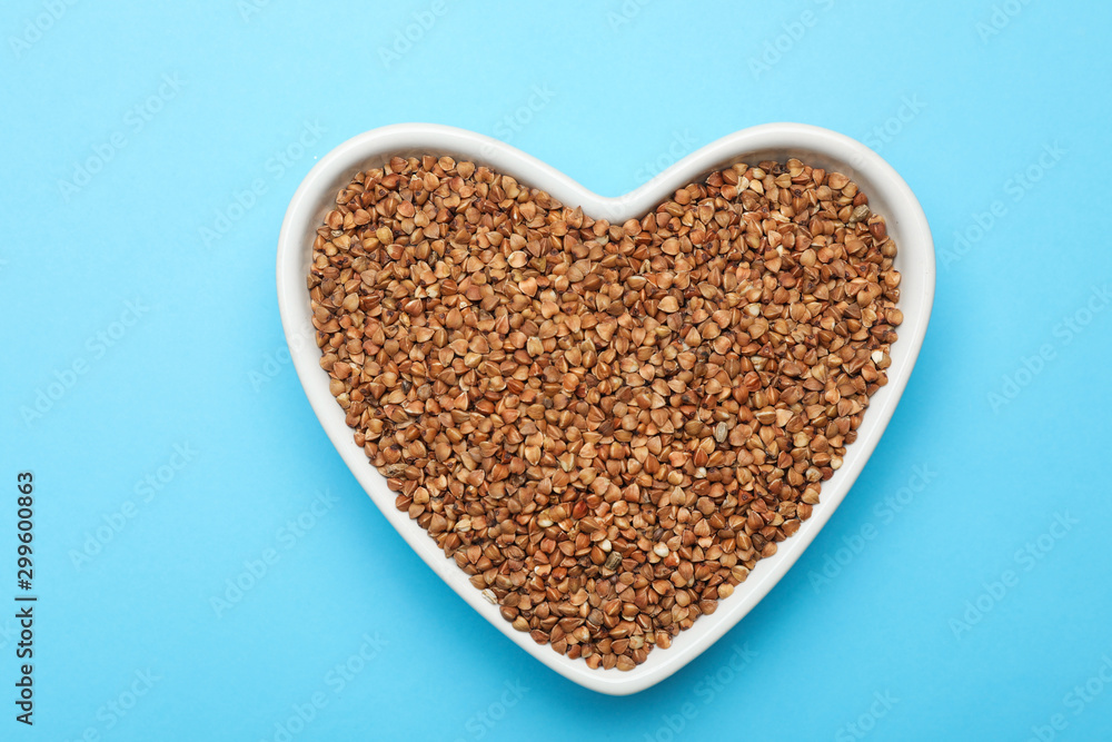 Buckwheat grains on light blue background, top view Buckwheat grains on light blue background, top view