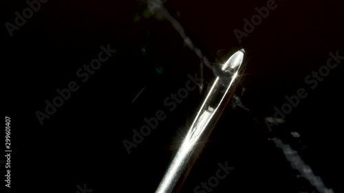 Threading through the eye of a needle in macro