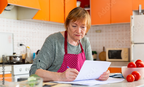 Focused woman signing paper documents