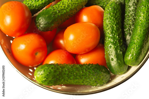 Tomatoes and cucumbers close up. ripe vegetables. healthy vegetarian food