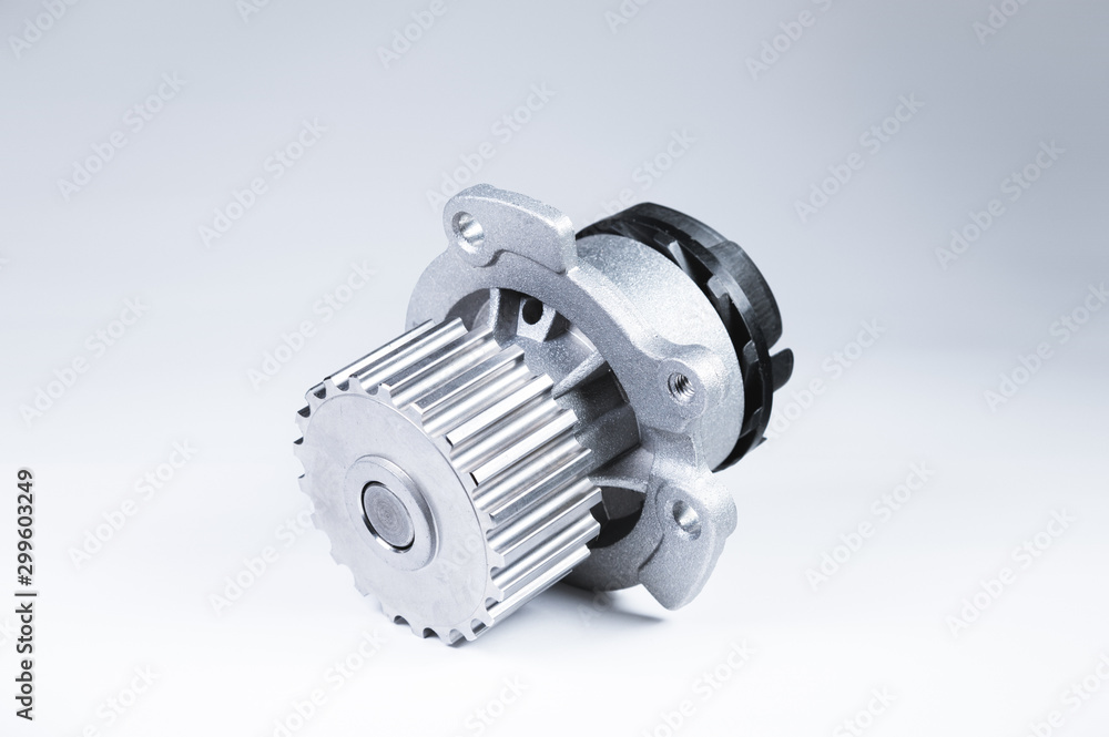 New metal automobile pump for cooling an engine water pump on a isolated white background. The concept of new spare parts for the car engine New metal automobile pump for cooling an engine water pump on a isolated white background. The concept of new spare parts for the car engine