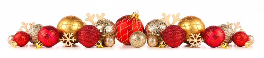 Christmas border of red and gold ornaments. Side view isolated on a white background.