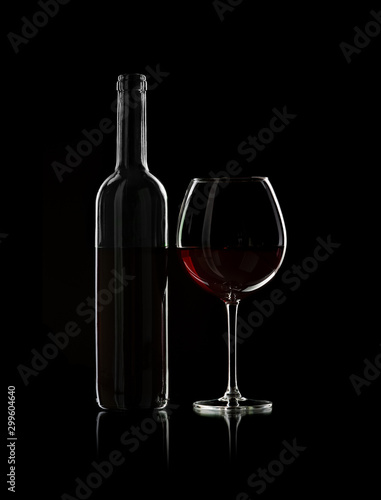 bottle and wine glass with red wine