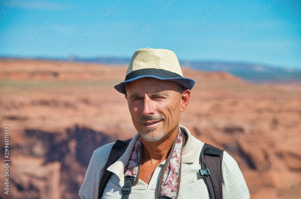 Happy man with straw hat enjoying Horseshoe Bend and Colorado River in the summer season
