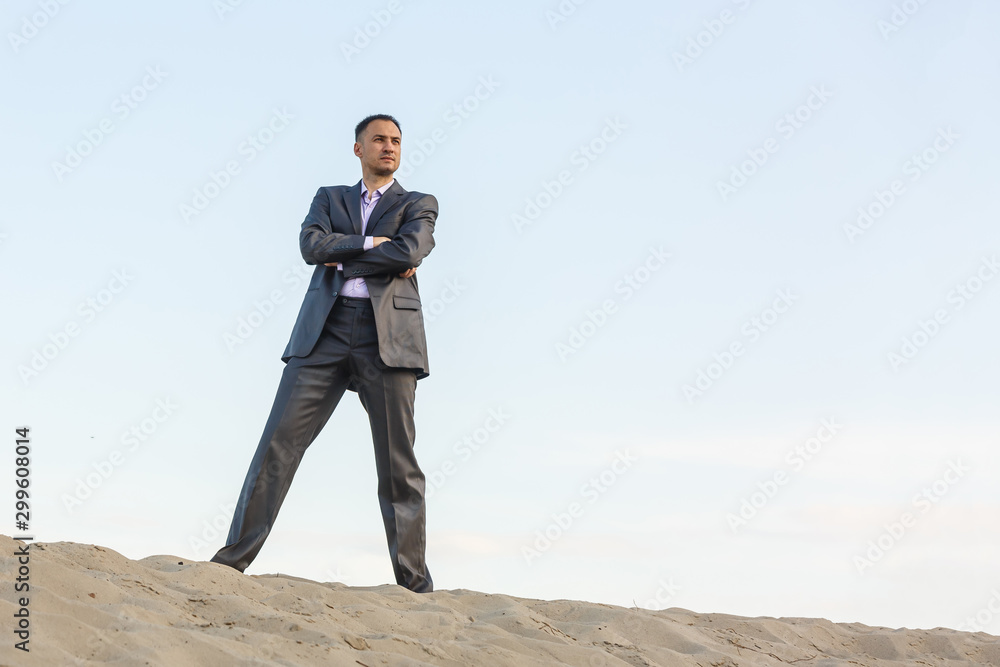 Handsome man elegantly dressed walking the desert Handsome man elegantly dressed walking the desert