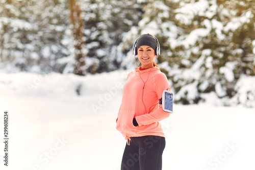 Girl athlete smiling while standing in the park in winter