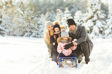 Family smiling in winter in a park