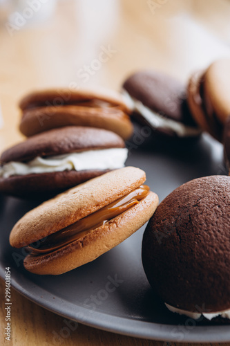 Close up Traditional chocolate and Pumpkin Whoopie pies made with vanilla cream cheese. Background for bakeries, cafes, restaurants photo