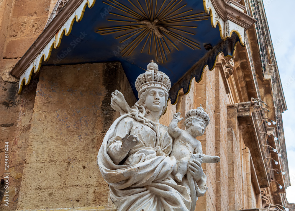 Blessed Virgin Mary and baby Jesus statue at the corner of Annunciation Church, also known as The Carmelite Church in Mdina, Malta.