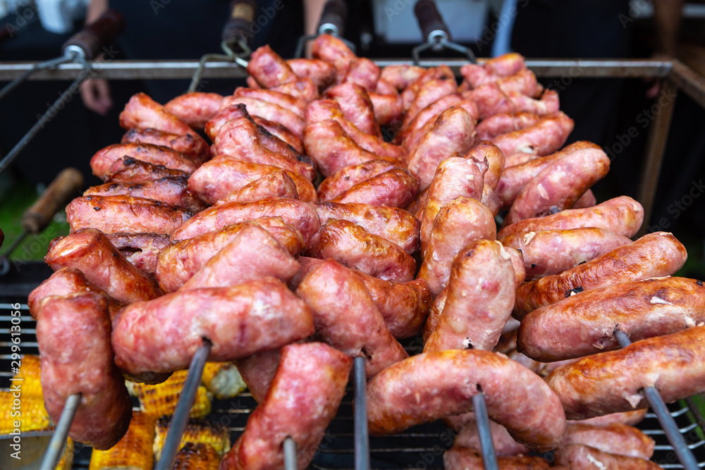 Closeup of delicious pork sausages roasted on the brazilian way barbecue grill. Selective focus. Concept of food, gastronomy, recipes, healthy eating and health.