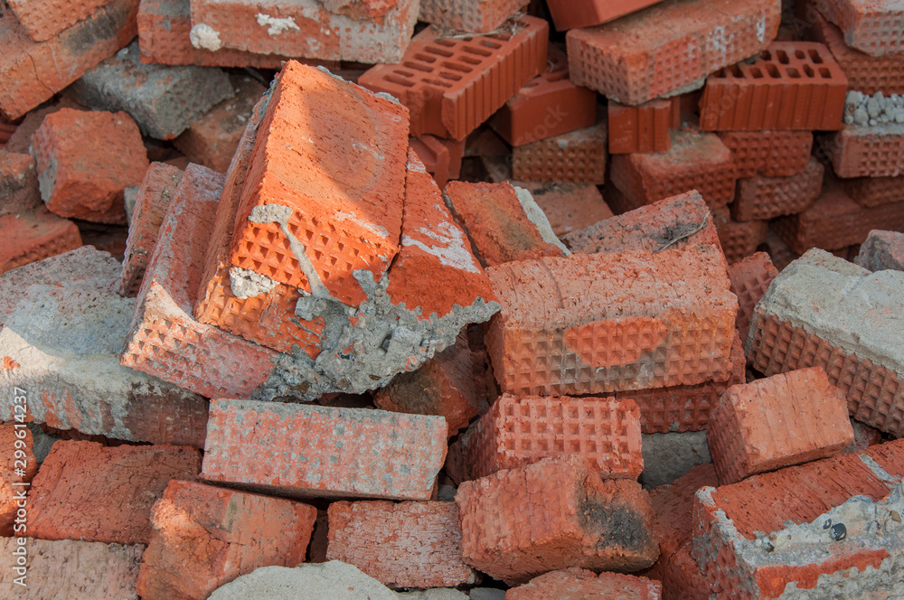 Background of red brick. Old red brick at a construction site. Old brick unsuitable for construction. Background of red brick. Old red brick at a construction site. Old brick unsuitable for construction.