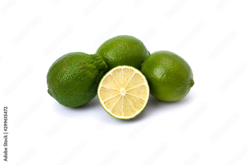 Lime green on a white background. Whole and halves limes isolated on white background. Full depth of field. Lime green on a white background. Whole and halves limes isolated on white background. Full depth of field.