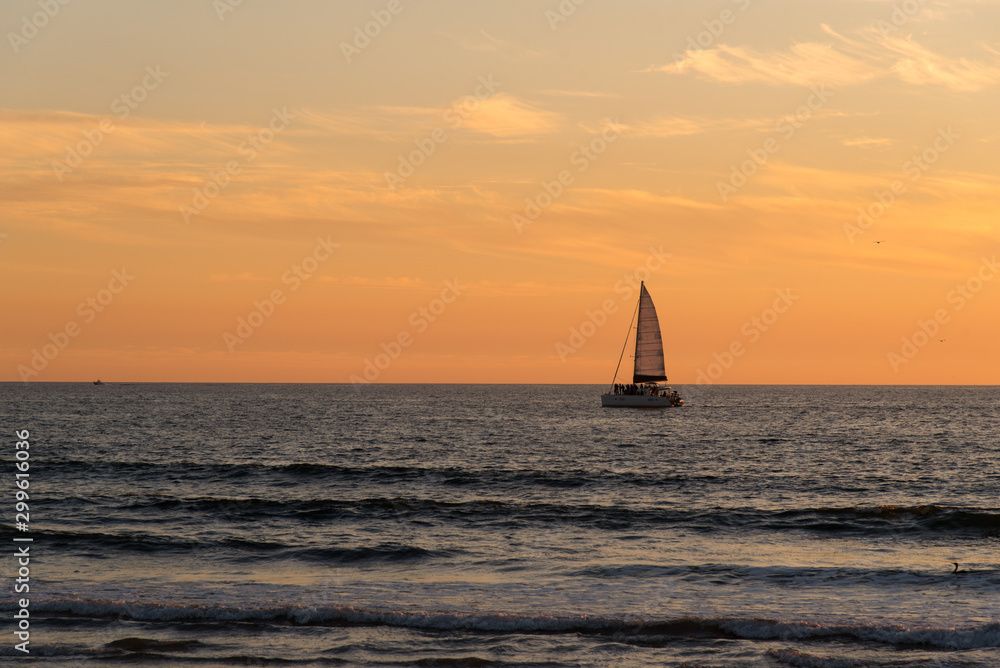 Sailboat at sunset in the Pacific Ocean