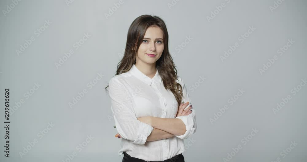 Young woman in formal wear with crossed hands isolated Young woman in formal wear with crossed hands isolated