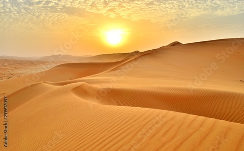 Fototapeta Naklejka Na Ścianę i Meble -  Sunset at the Edge of the Rolling Sand Dunes in the Empty Quarter (Desert) outside Abu Dhabi, United Arab Emirates