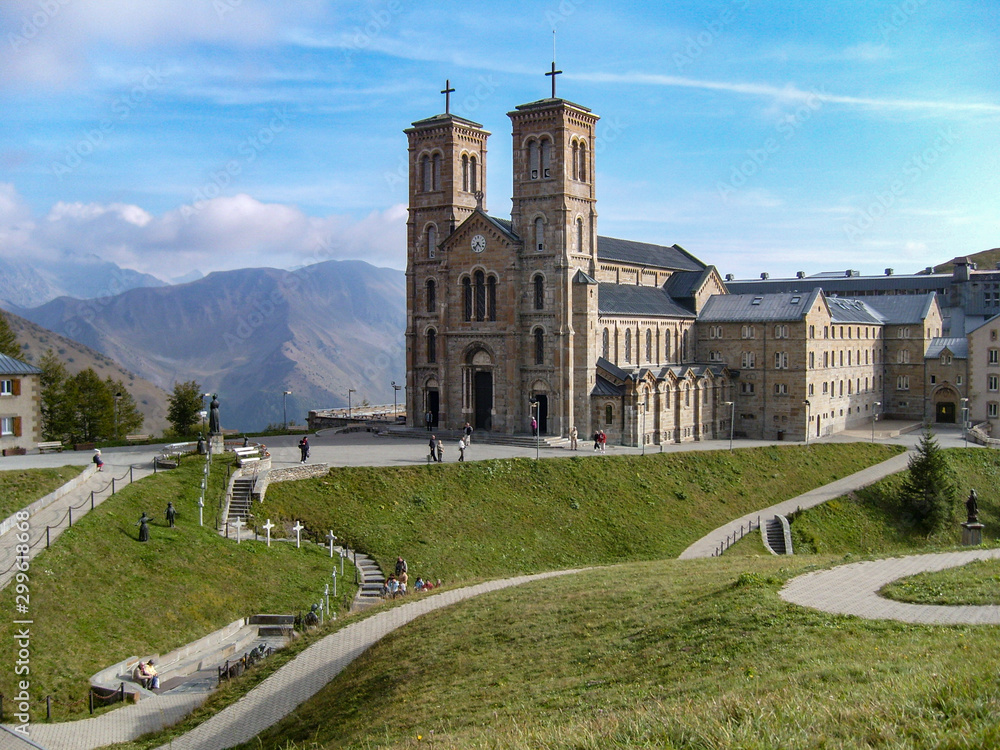 Fototapeta premium Shrine of Our Lady of La Salette between mountains French Alps. Sanctuary in the town of La Salette-Fallavaux in the Provence-Alpes-Côte d'Azur. Hautes-Alpes, France