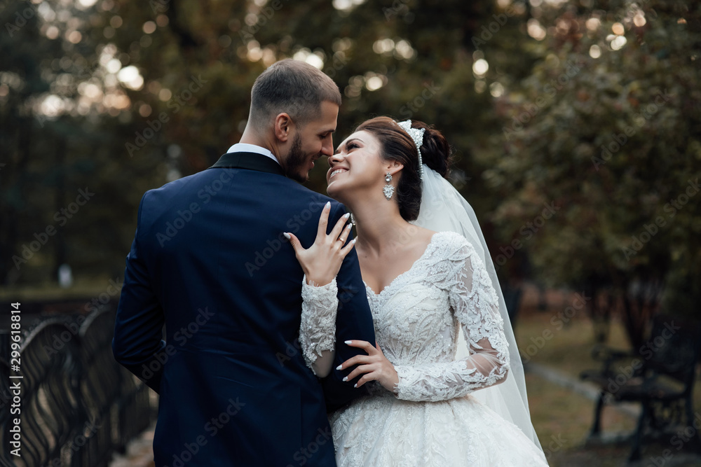 Bride and groom embrace. Married couple embracing and looking at each other. Wedding couple day. Beautiful makeup and hairstyle. Portrait of lovely couple Bride and groom embrace. Married couple embracing and looking at each other. Wedding couple day. Beautiful makeup and hairstyle. Portrait of lovely couple
