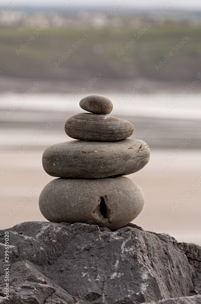 Balanced Rock Zen Stack at Lahinch Beach in county Clare. West coast of Ireland. No people, vertical photo. Selective focus. Balanced Rock Zen Stack at Lahinch Beach in county Clare. West coast of Ireland. No people, vertical photo. Selective focus.