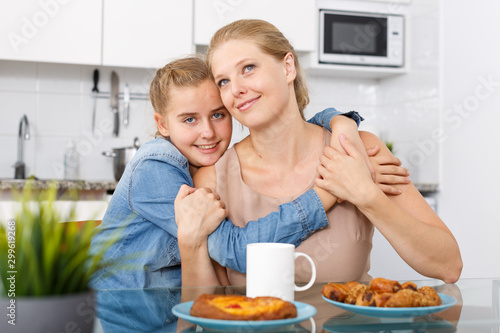 Smiling woman and her teenage daughter