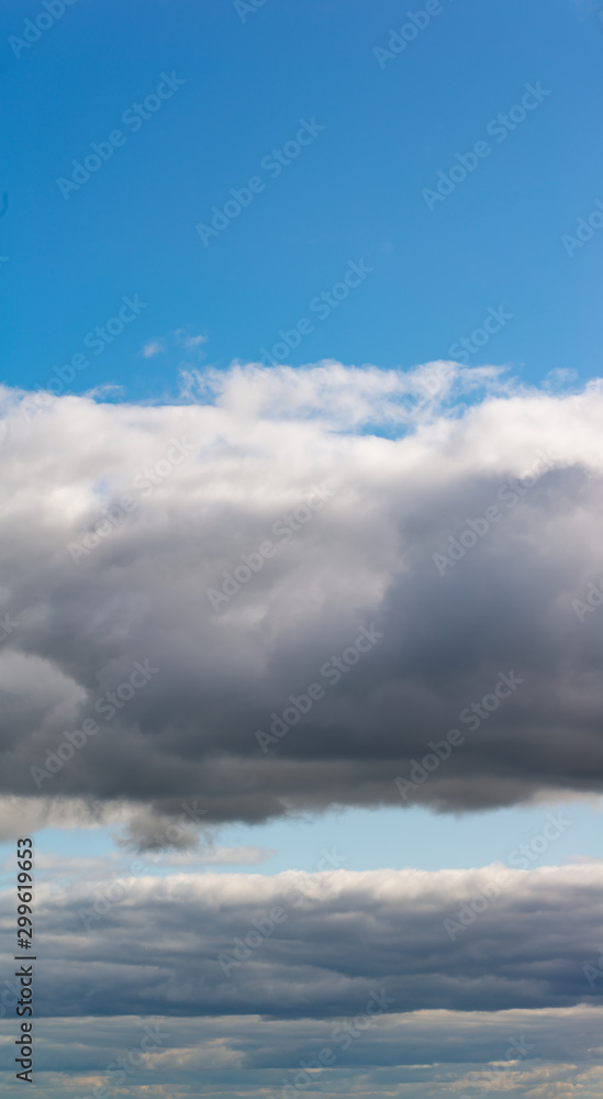 Fantastic clouds against blue sky, panorama