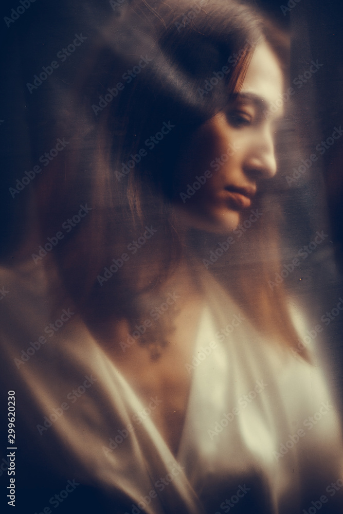 Abstract mysterious portrait girl hidden white behind cellophane Abstract mysterious portrait girl hidden white behind cellophane