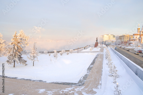 Winter landscape of frosty trees, white snow in city park. Trees covered with snow in Siberia, Irkutsk near lake Baikal. Extremely cold winter