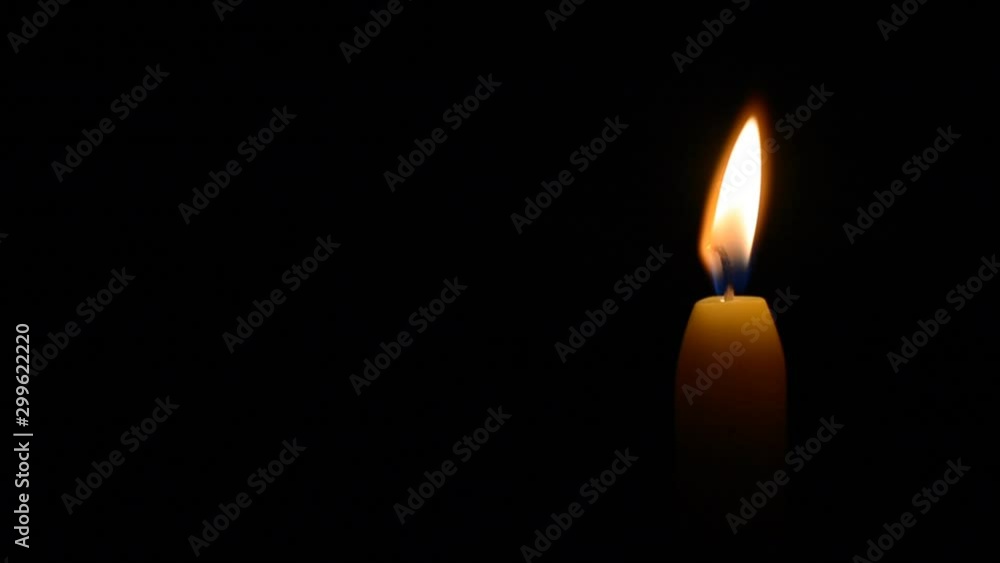 Simple burning candle on a black background, left balck copyspace hd stock footage Simple burning candle on a black background, left balck copyspace hd stock footage