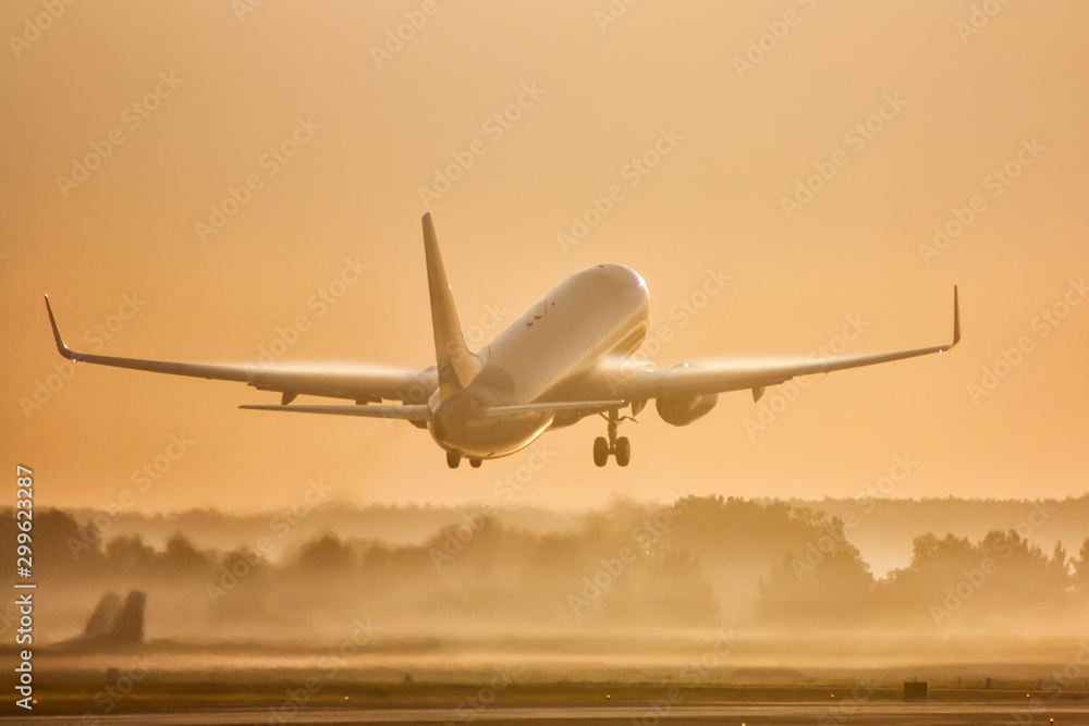 Passenger airplane take off in morning fog