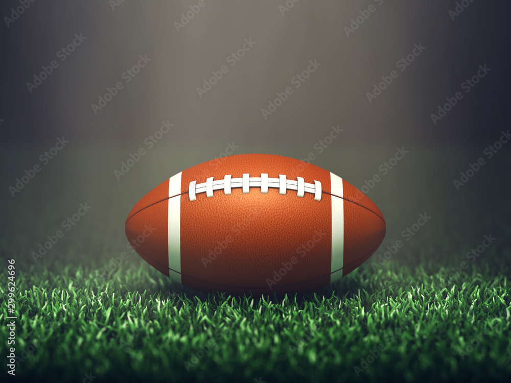 American football ball on grass lit by spotlight, Sport stadium American football ball on grass lit by spotlight, Sport stadium